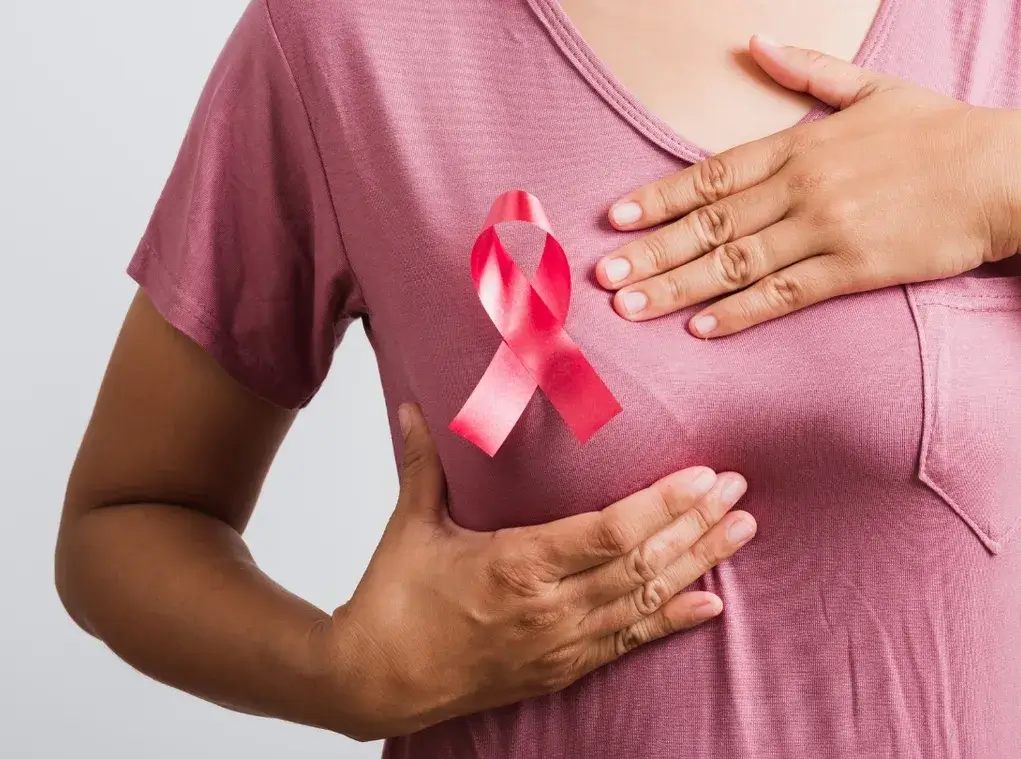 Pink cancer awareness ribbon representing compassionate home cleaning support